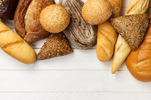 Preview: Assortment of fresh bread on a white wooden background. top view with copy space