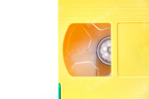 Preview: yellow videotape Isolated on white background. Creative concept in retro style, 80s.