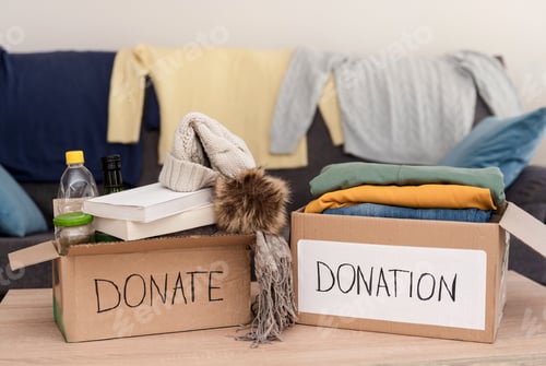 Preview: Cardboard boxes overflowing with clothing and food donations for charity