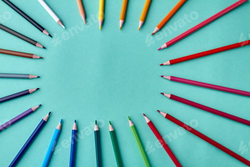 Preview: Frame from colored pencils on turquoise background.