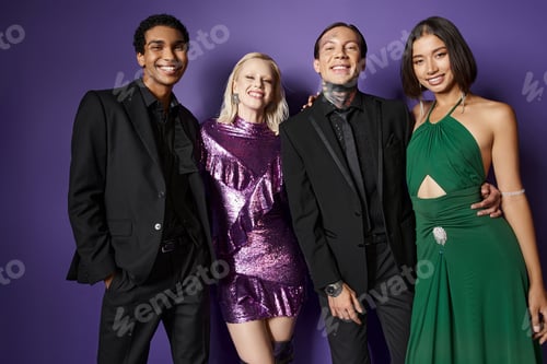 Preview: Merry Christmas, joyful multiethnic male and female friends in festive attire hugging on purple