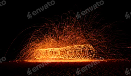 Preview: Fire dancer swing fire dancing show on celebration with dark sky background.