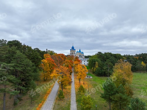 Preview: Tree-lined avenue leading to a blue-domed church