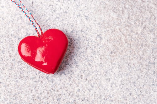 Preview: Red toy heart on granite stone textured background. Valentines day concept. Top view, flat lay