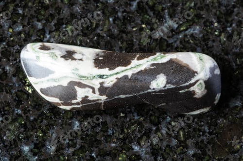Preview: sample of tumbled hornfels mineral on black