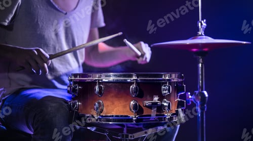 Preview: A drummer plays drums on a blue background.