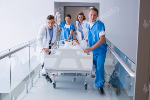 Preview: Doctors pushing emergency stretcher bed in corridor