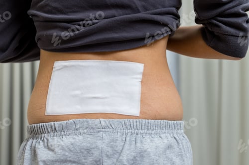 Preview: Woman relieving muscle pain with patch