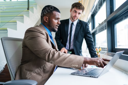 Preview: Two happy business woman and man using laptop working at workplace.