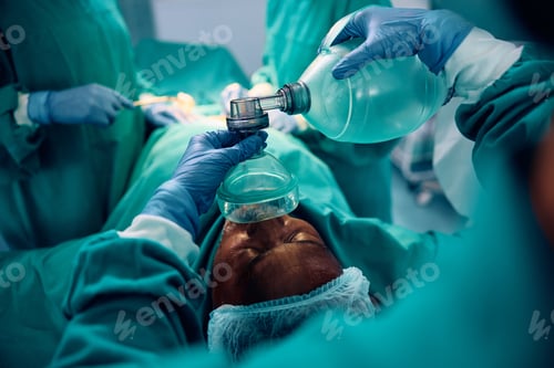 Preview: Close up of anesthesiologist using oxygen mask on patient during surgery in the hospital.