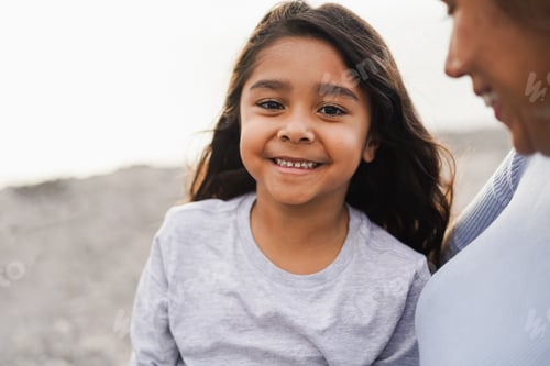 Preview: Happy latin daughter and mother having fun together during spring time outdoor
