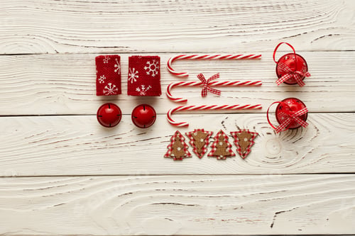 Preview: Christmas Ornaments and Candy Canes on Wood Table