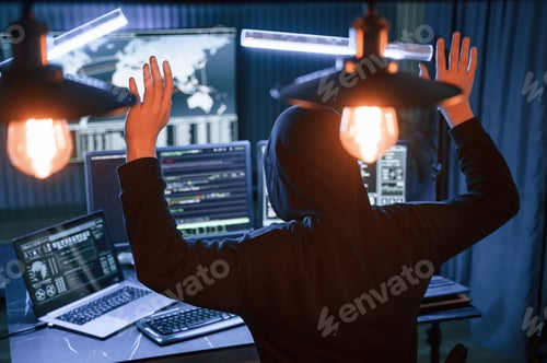 Preview: Got caught. With hands up. Male professional hacker is sitting by computer, conception of virus