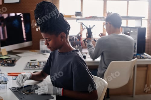 Preview: Female Electronic Repair Person Fixing Faulty Phone
