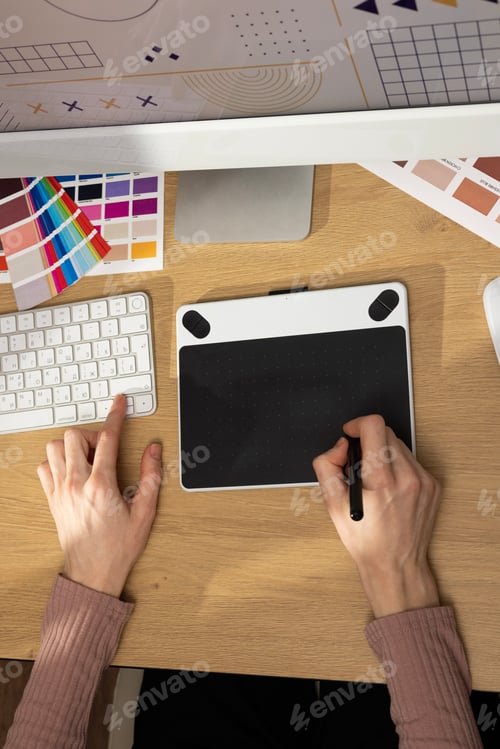Preview: Designer working on a graphic tablet at a desk. Creative creation of graphic design, artist