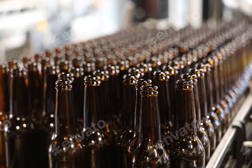 Preview: Factory production line with a conveyor belt carrying beer bottles