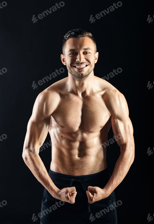Preview: Sexy muscular shirtless man against dark background