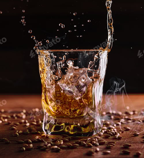 Preview: Splash of whiskey from an ice cube in glass
