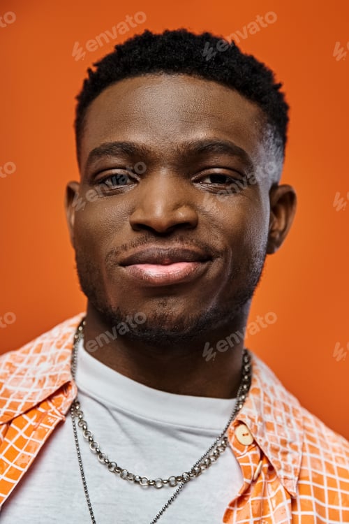 Preview: Stylish Young Man Rocking Orange Shirt and Chain