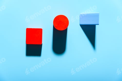 Preview: Three geometric figures of solid colors illuminated with hard light on simple blue background.