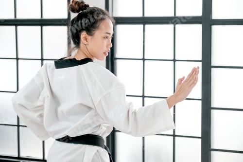 Preview: Young teacher of taekwondo show some posture that use hand fight forward to the opposite.