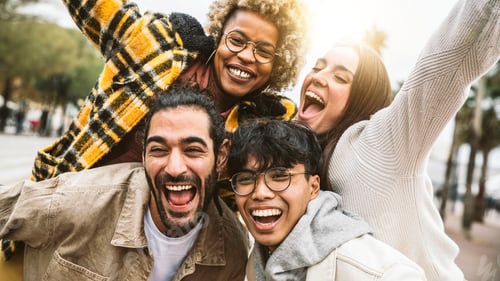 Preview: Group of four best friends laughing out loud outside