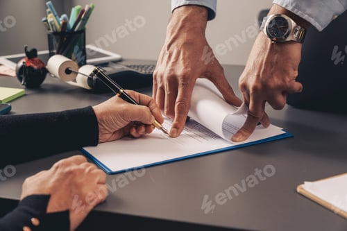 Preview: Business contract signing with hands, pen, and documents on desk