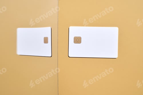 Preview: Minimalist design with two white credit cards on yellow background reflecting