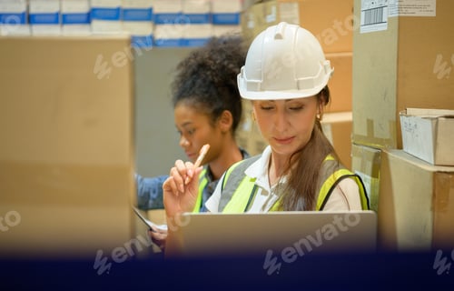 Preview: Two female warehouse worker Counting items in an industrial warehouse