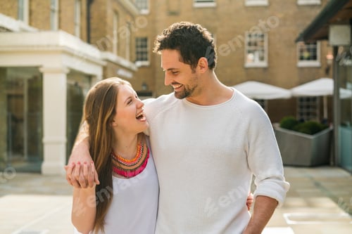 Preview: Young couple laughing on Kings Road, London, UK