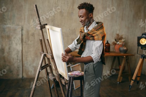 Young Adult Artist Painting in a Studio