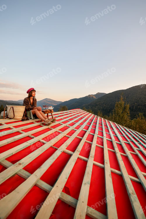 Preview: Woman enjoys beautiful sunset in the mountains