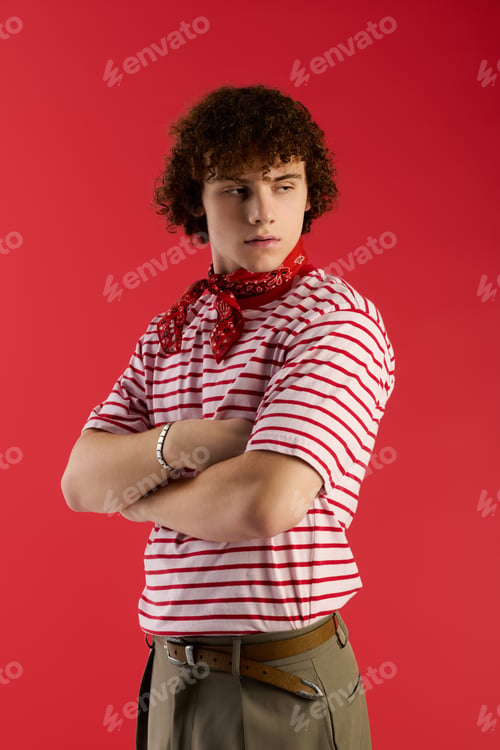 Preview: Teenager showcases trendy style with confidence against a vibrant red background