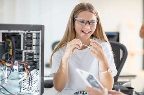 Preview: Happy students assembling computer in class