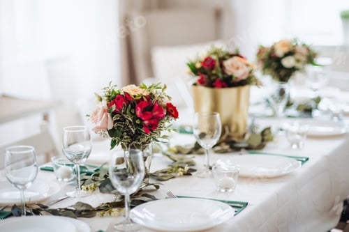 Preview: Table set for a meal indoors in a room on a party, a wedding or family celebration.