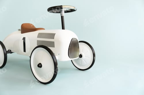 Preview: Retro style beige toy car on blue background. Stylish toy for toddler boy.