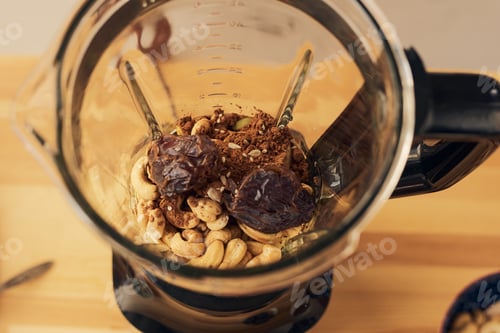 Preview: Electric blender with ingredients for smoothie standing on table