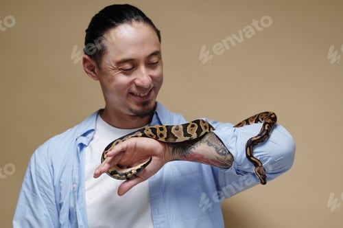 Preview: Smiling Man Holding Snake on His Arm