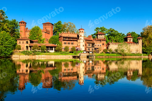 Preview: Scenic view of a Medieval village reflecting in a river in Valentino park on a sunny day