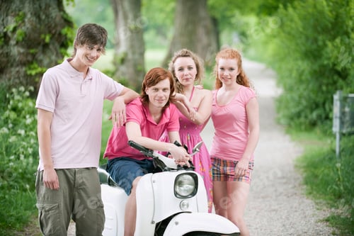Preview: Germany, Bavaria, Four friends standing by moped, portrait
