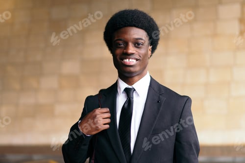 Preview: Friendly African Businessman with Backpack in Warm Indoor Light