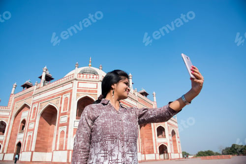 Preview: Young girl taking Photos in front of Humayun's Tomb, Delhi, India.