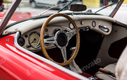 Preview: Red retro car's inside. Woodened wheel. Old tymer inside.