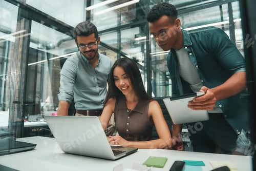 Preview: Business people. Group of three young and cheerful employees using modern technologies while