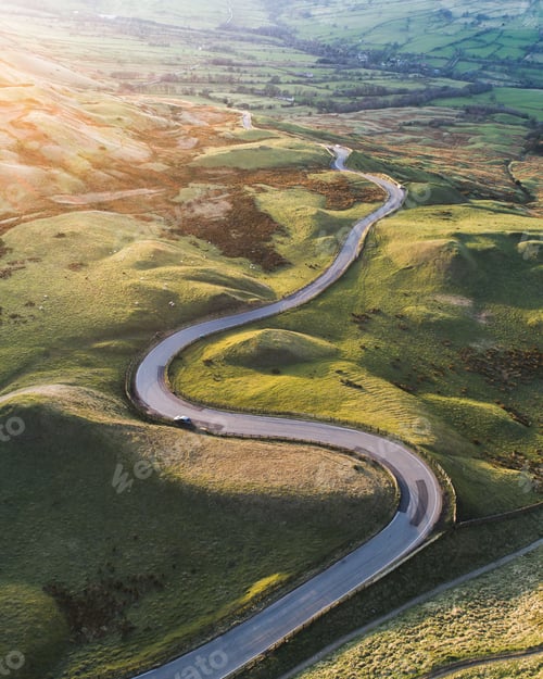 Preview: a view from above on the winding road with mountains in the background