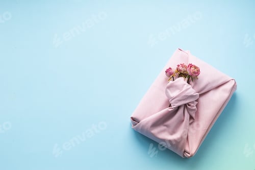 Preview: Holiday gift wrapped fabric in manner of Furoshiki blue background. Concept Zero Waste