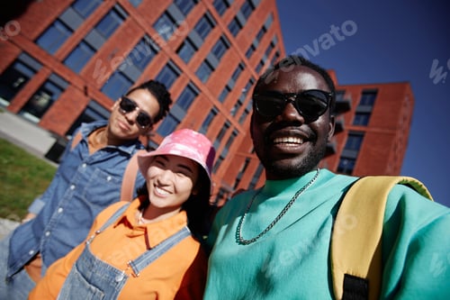 Preview: POV of three diverse young students taking selfie photo outdoors