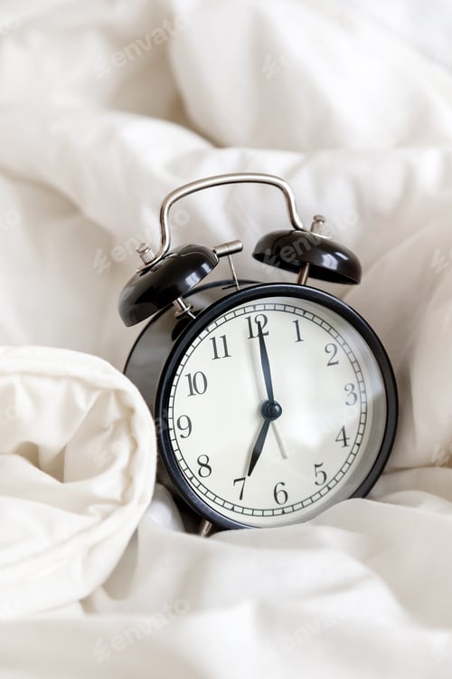 Preview: Classic alarm clock in bed, concept of morning routine