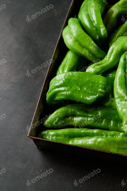 Preview: Vertical closeup shot of a box full of green chili peppers also known as Anaheim Pepper