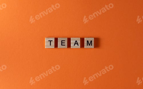 Preview: Team word phrase in wooden letters. Motivation and slogan. Orange background
